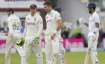 Pacer James Anderson, right, speaks to England's Jos Buttler