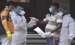 Relatives of Covid patient interact with health worker