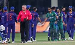 Indian, in blue, and Pakistan's cricketers greet each other at the end of the Cricket Twenty20 World