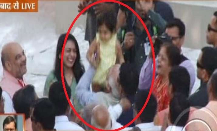 PM Narendra Modi embraces a child