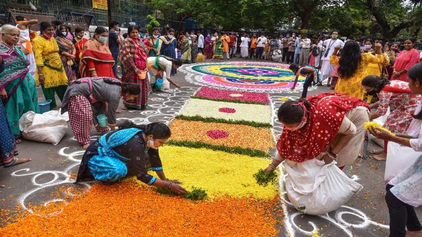 Women devotees make rangoli during Lord Jagannath Rath Yatra in Hyderabad