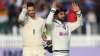 Virat Kohli celebrates as James Anderson reacts after day