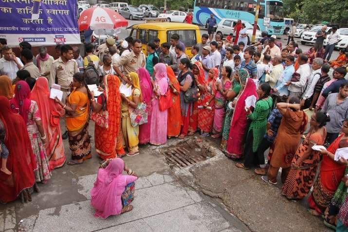 Pilgrims wait in queues to get themselves registered for
