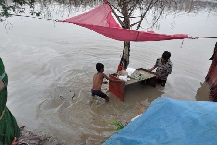 People shift their belongings to drier area as he evacuate