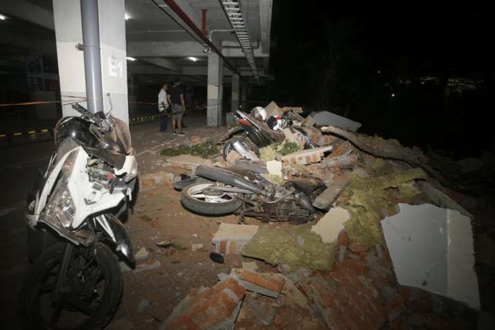 Debris on top of a motorcycles after an earthquake in Bali,