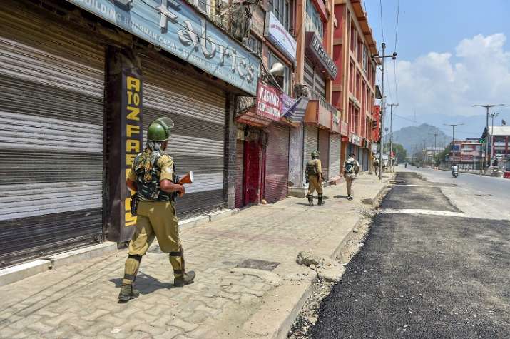 Srinagar: Security personnel patrol a street during a