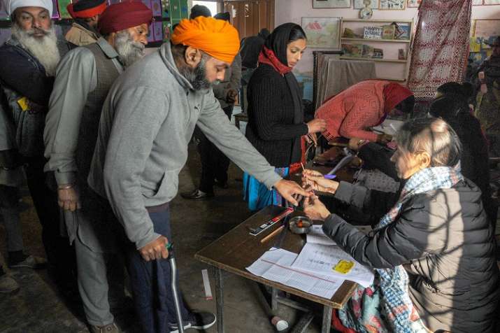 An election officer puts indelible ink mark on the finger