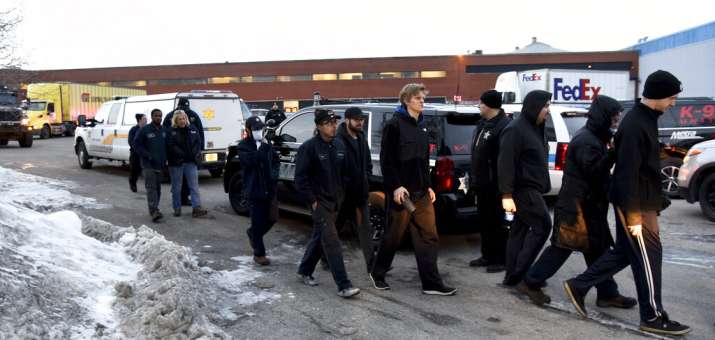 Employees are escorted from the scene of shooting