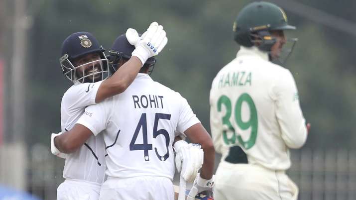 India's Ajinkya Rahane, left, hugs teammate Rohit Sharma to