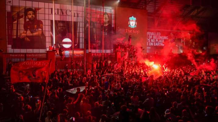 Liverpool soccer fans let off flares outside the Liver