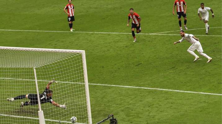 Real Madrid's Sergio Ramos, right, scores the opening goal