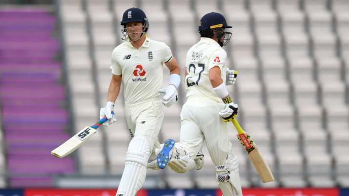 Joe Denly and Rory Burns of England run between the wickets