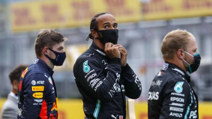 Mercedes driver Lewis Hamilton of Britain, center, stands