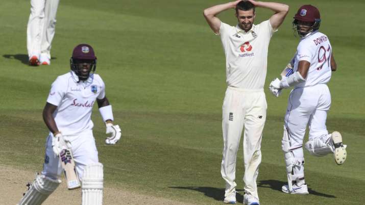 England's Mark Wood, center, reacts as West Indies'