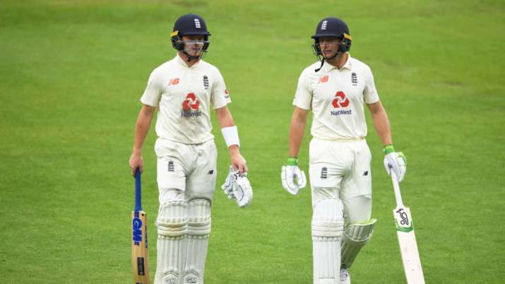 Ollie Pope and Jos Buttler of England leave the field as