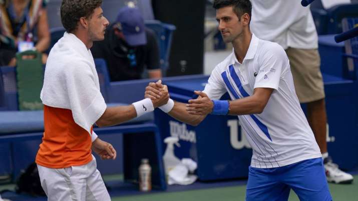 Novak Djokovic, of Serbia, shakes hands with Pablo Carreno