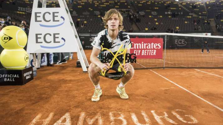 Andrey Rublev of Russia holds the trophy after his victory