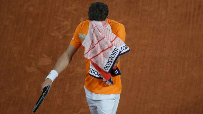 Spain's Pablo Carreno Busta wipes his face in the fourth