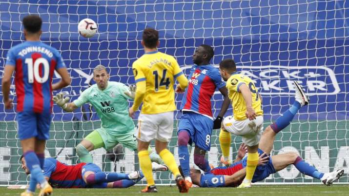 Brighton's Neal Maupay, right gets his shot deflected over