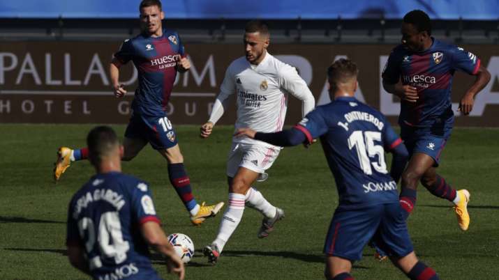 Real Madrid's Eden Hazard, center, runs with the ball next