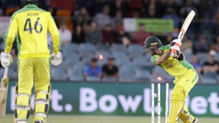 Australia's Glenn Maxwell, right, is bowled by India's