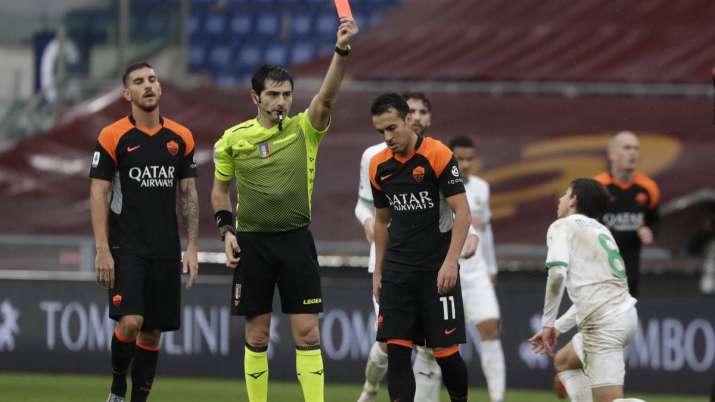 Roma's Pedro, centre, is shown the red card by the referee