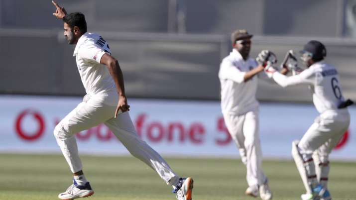 India's Ravichandran Ashwin, left, celebrates taking the