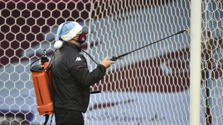 The goal post is sprayed with disinfectant before the