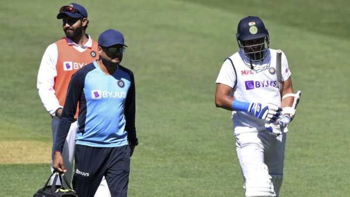 India's Mohammed Shami, right, retires hurt after he was