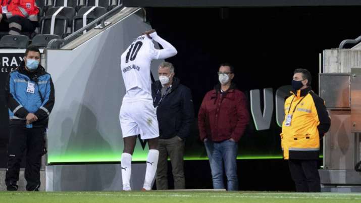 Moenchengladbach's Marcus Thuram leaves the pitch after