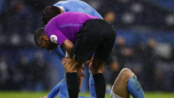 Manchester City's John Stones reacts injured at the ground