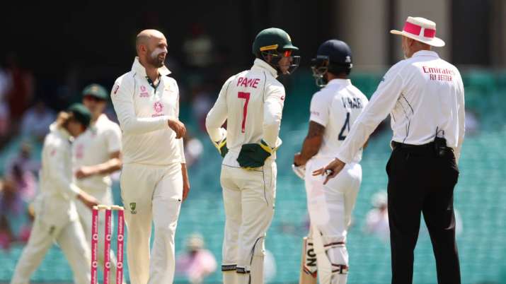 Tim Paine and Nathan Lyon of Australia questions Umpire