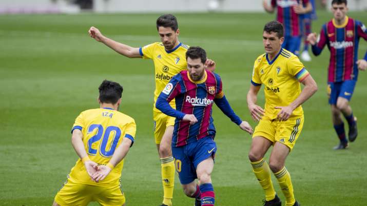 Barcelona's Lionel Messi, center, controls the ball during