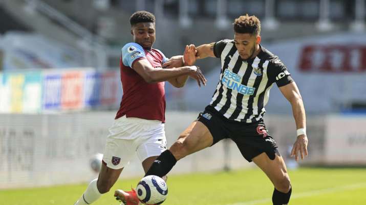 Newcastle's Joelinton, right, battles for the ball with