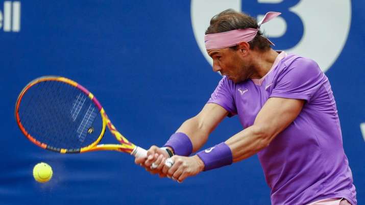 Rafael Nadal of Spain returns the ball to Ilya Ivashka of