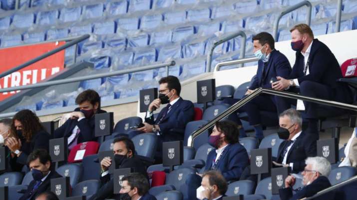 Barcelona's head coach Ronald Koeman, top right, watches