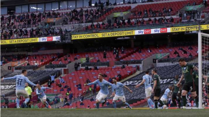 Manchester City's Aymeric Laporte, center, celebrates after