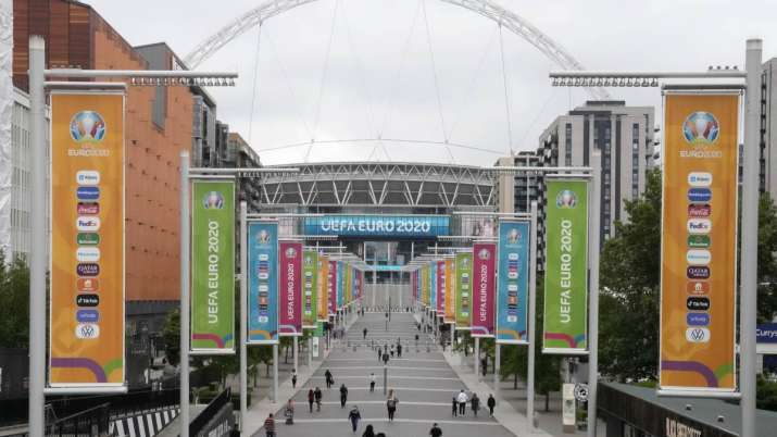 People walk the road to Wembley stadium during the Euro