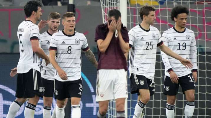 Latvia's Eduards Emsis, front, reacts during the