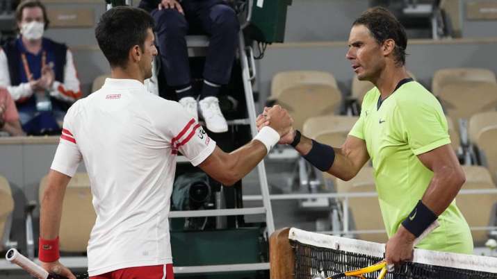 Serbia's Novak Djokovic, left, shakes hands with Spain's