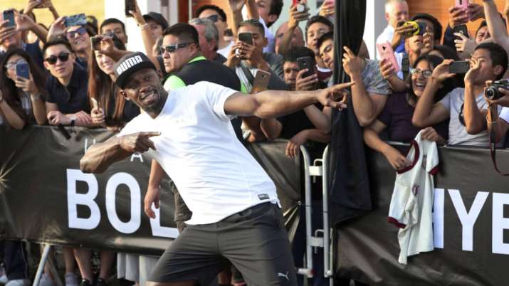 Jamaican sprinter Usain Bolt strikes his now-famous victory