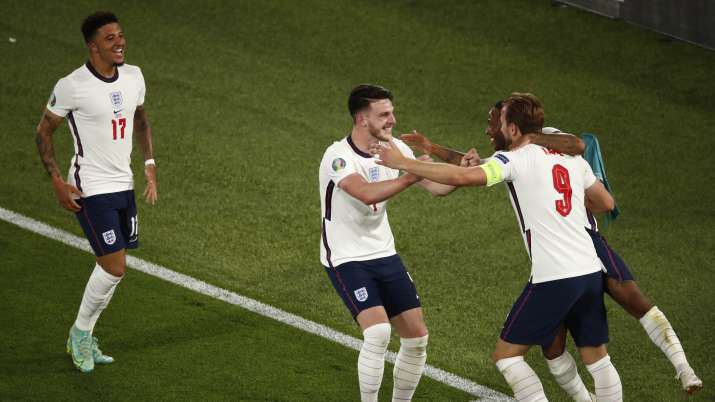 England's Harry Kane, right, celebrates after scoring his
