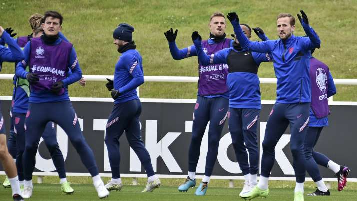 England's Harry Kane, right, warms-up with teammates during