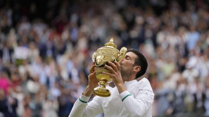 Serbia's Novak Djokovic kisses the winners trophy as he