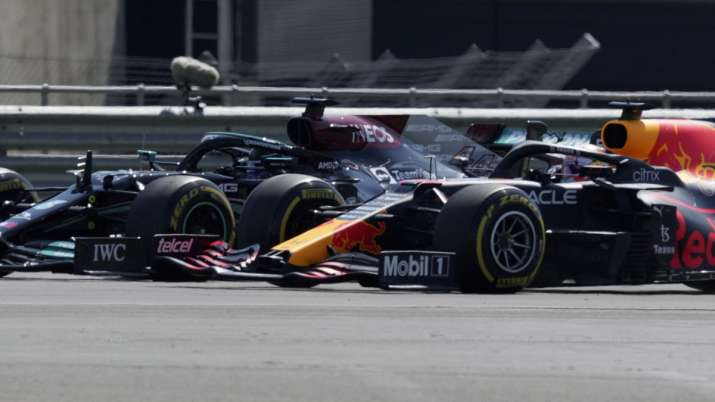 Mercedes driver Lewis Hamilton of Britain, left, and Red