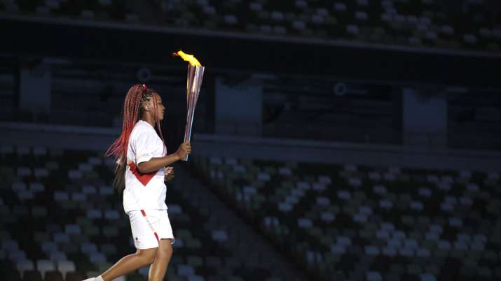 Naomi Osaka carries the Olympic Torch during the opening