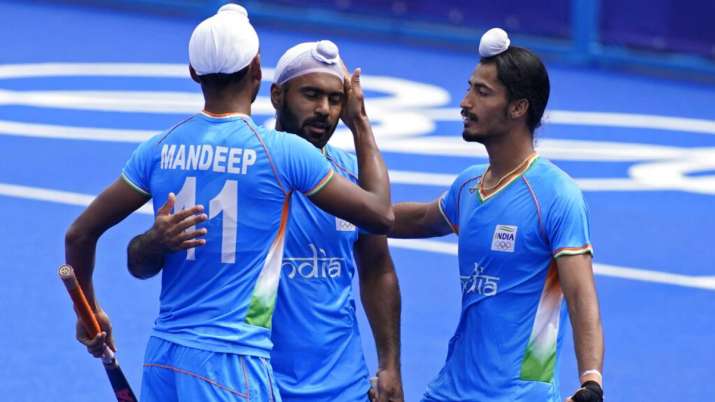 India's Mandeep Singh celebrates after India's Simranjeet Singh scores against Spain.