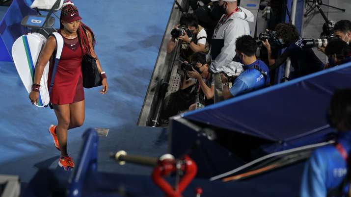 Naomi Osaka, of Japan, leaves center court after being