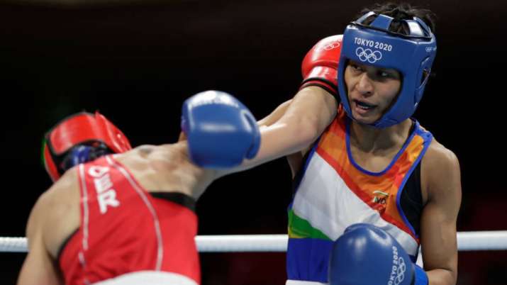 Nadine Apetz (red) of Germany exchanges punches with Lovlina Borgohain of India