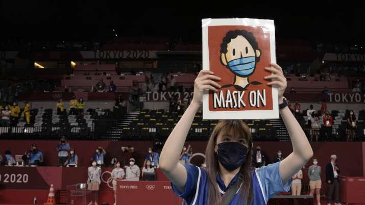A volunteer holds a sign telling players to keep their